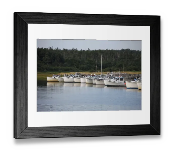 Framed Print : Row of boats docked in a tranquil harbor with forest in the background in rural Prince Edward Island Framed Print : Row of boats docked in a tranquil harbor with forest in the background in rural Prince Edward Island