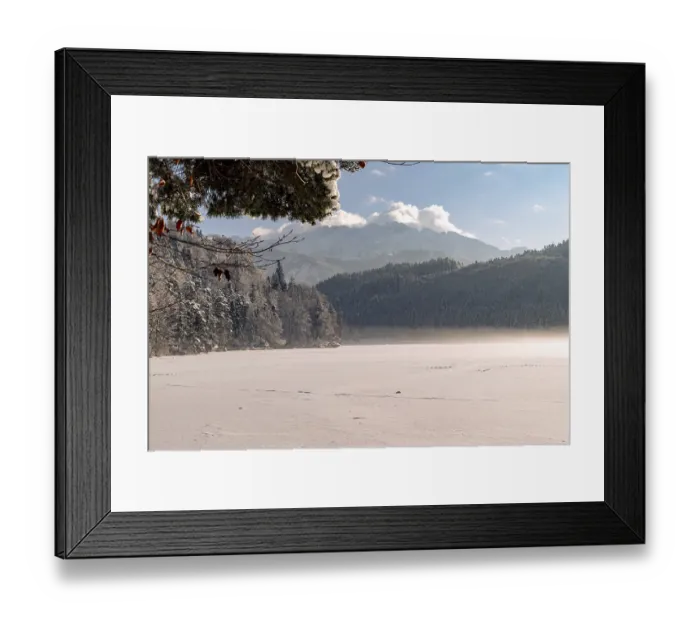 Framed Print : Snowy lake with mountains in the background under a clear blue sky with few clouds Framed Print : Snowy lake with mountains in the background under a clear blue sky with few clouds