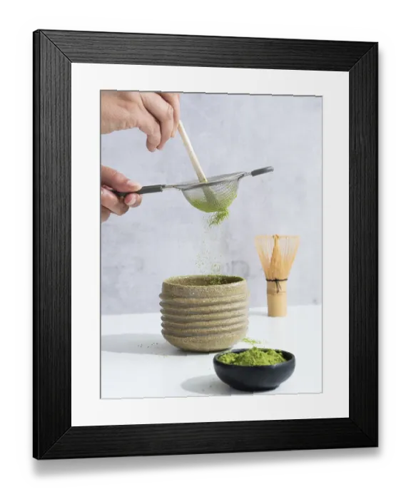 Framed Print : Hand sifting matcha powder through a sieve into a ceramic tea bowl during preparation