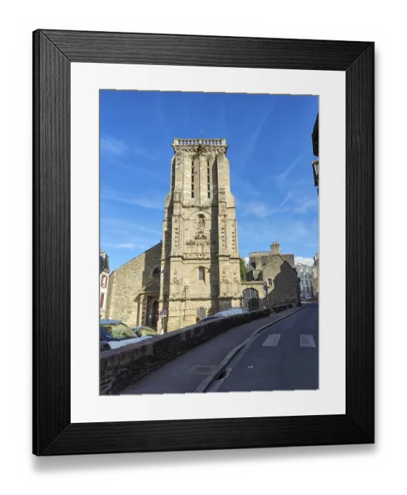 Framed Print : A stone church tower rises at the end of an urban road