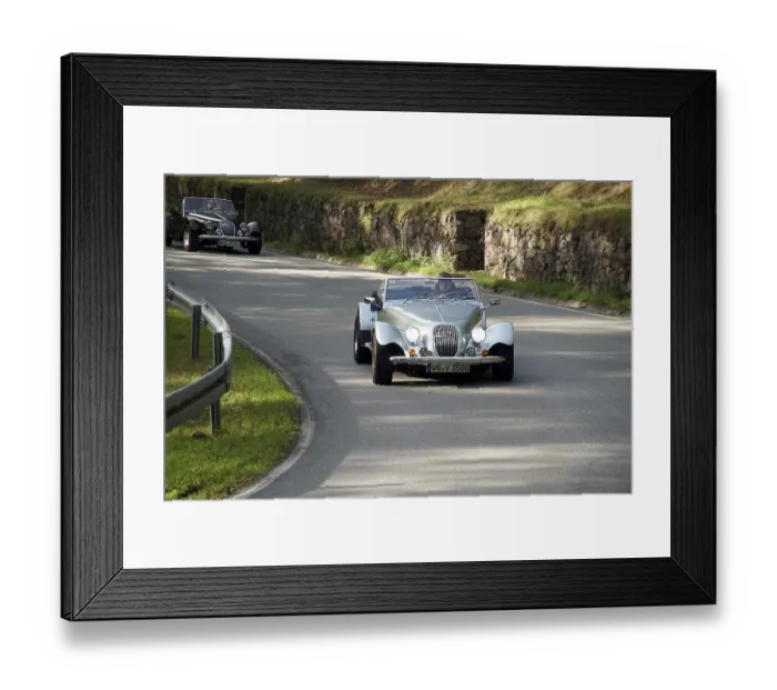 Framed Print : Vintage car convoy on a winding road next to a stone wall Framed Print : Vintage car convoy on a winding road next to a stone wall