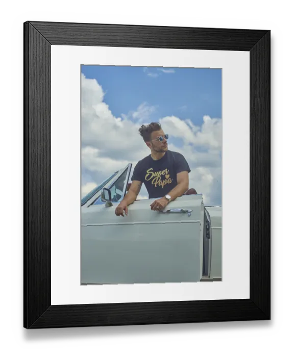 Framed Print : Man in sunglasses leaning on a white convertible car with a cloudy sky backdrop Framed Print : Man in sunglasses leaning on a white convertible car with a cloudy sky backdrop