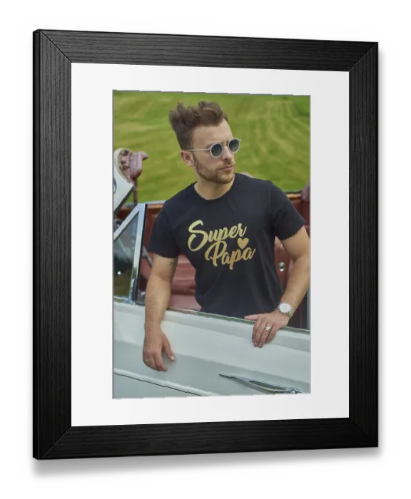 Framed Print : Man in a black shirt and sunglasses leaning against a white convertible in a green field