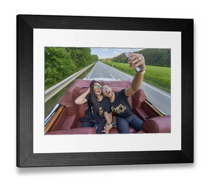 Framed Print : A couple in a convertible takes a selfie on a sunny road trip Framed Print : A couple in a convertible takes a selfie on a sunny road trip
