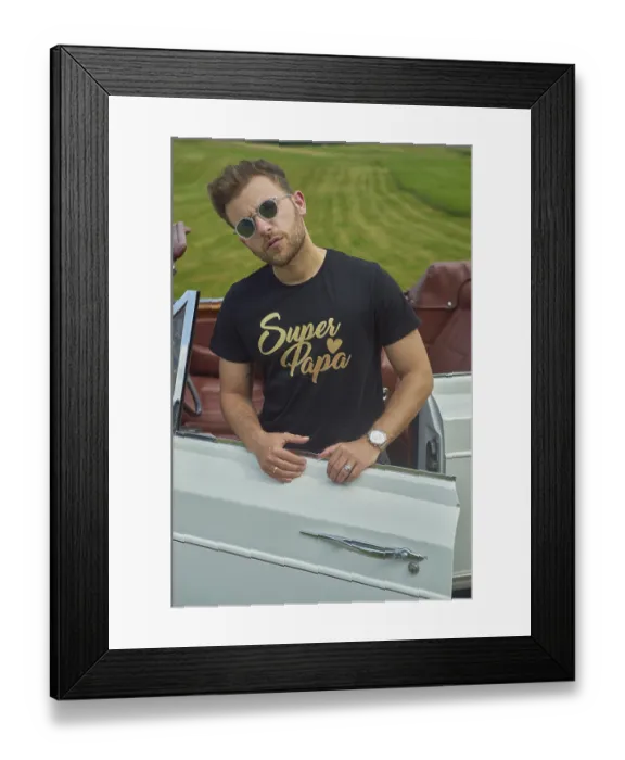 Framed Print : Man leaning on a white convertible wearing a black shirt and sunglasses in a field