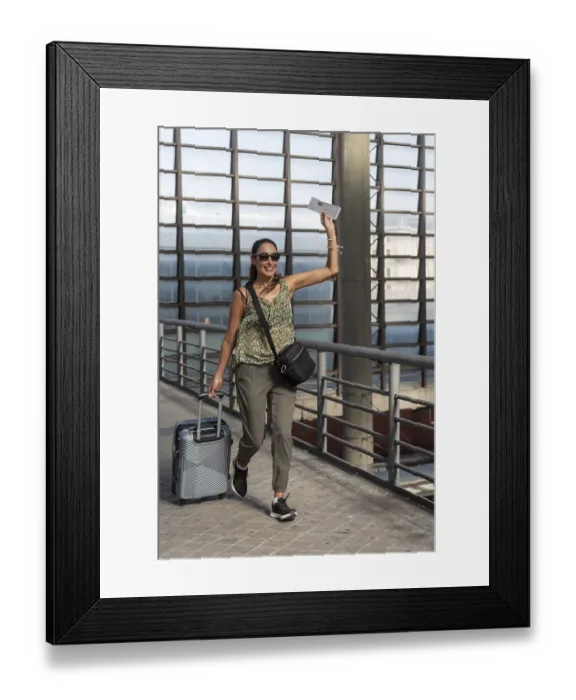 Framed Print : Smiling woman traveler pulling suitcase