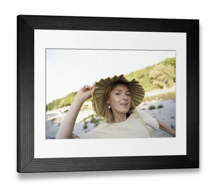 Framed Print : A joyful woman in a straw hat offers a playful pose outdoors in a summer setting on Praterinsel of river Isar in Munich