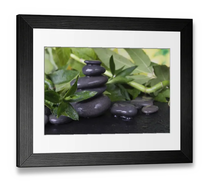 Framed Print : Spa concept with gray wet massage stones and lush green foliage covered with water drops on a black background Framed Print : Spa concept with gray wet massage stones and lush green foliage covered with water drops on a black background