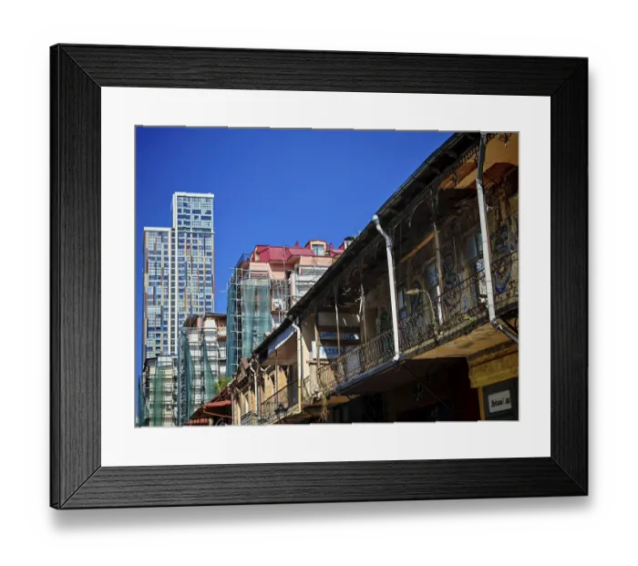 Framed Print : Modern and old architecture contrasting under clear skies