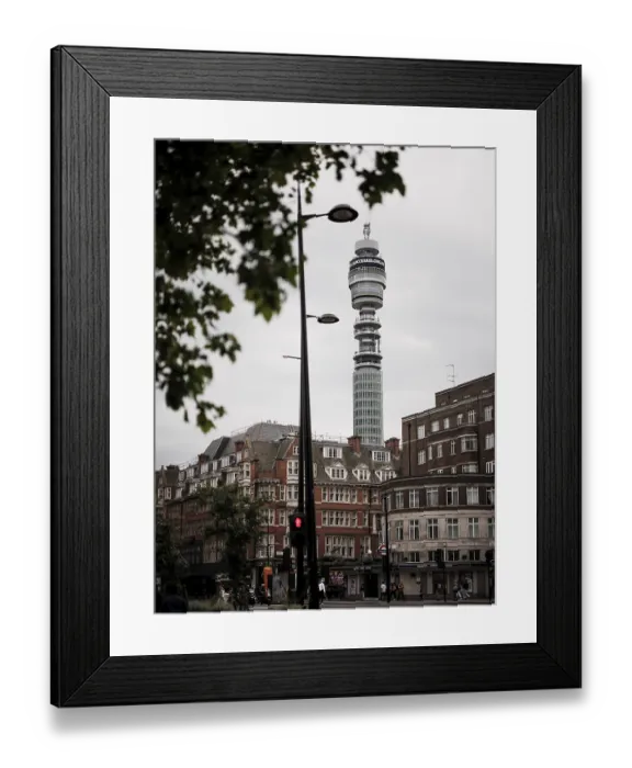 Framed Print : Tower rises above city buildings against a cloudy sky in Greater London