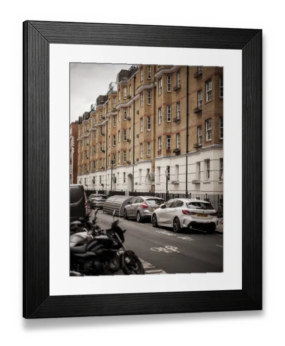 Framed Print : Urban street lined with parked cars and residential buildings in Greater London Framed Print : Urban street lined with parked cars and residential buildings in Greater London
