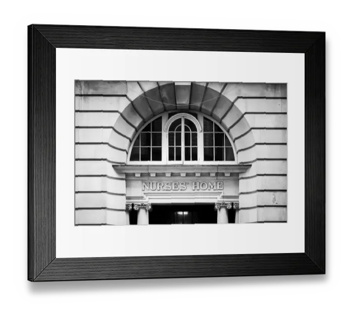 Framed Print : Black and white image of an arched window above the entrance to a historic building in Greater London Framed Print : Black and white image of an arched window above the entrance to a historic building in Greater London