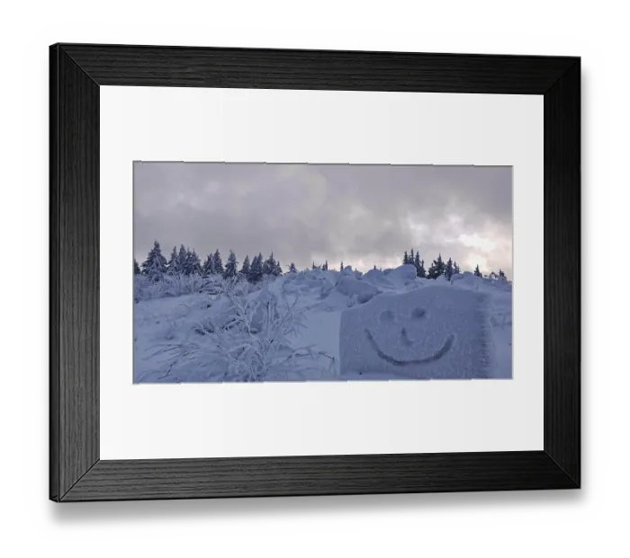 Framed Print : Snowy forest with a smiley face drawn in snow under a cloudy sky Framed Print : Snowy forest with a smiley face drawn in snow under a cloudy sky