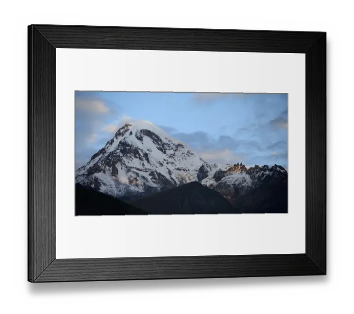 Framed Print : Majestic snow-covered mountain under cloudy sky