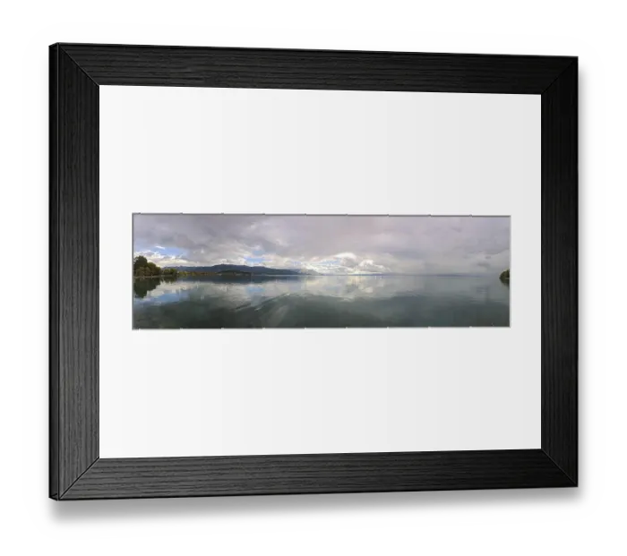 Framed Print : Panoramic picture of a calm lake with mountains and clouds in the background Framed Print : Panoramic picture of a calm lake with mountains and clouds in the background
