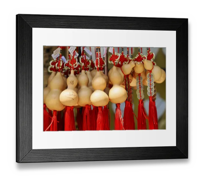 Framed Print : Wooden pumpkin bottles with red tassels symbolize good fortune and prosperity