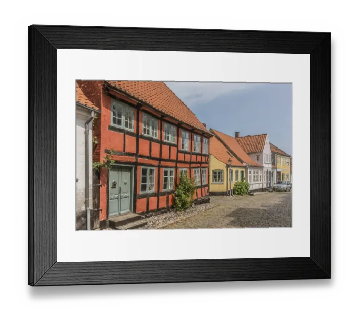 Framed Print : The facade of a red two stock half-timbered house in a cobbled street Framed Print : The facade of a red two stock half-timbered house in a cobbled street