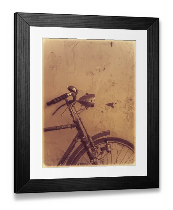 Framed Print : Old rusty vintage bicycle leaning against a wall in a countryside