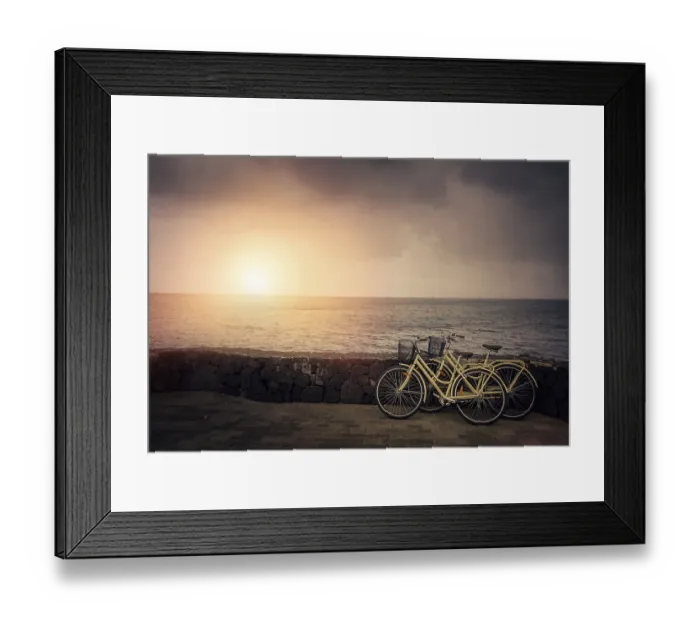 Framed Print : Two old retro vintage bicycles rested on a stone wall on the seaside in Lanzarote