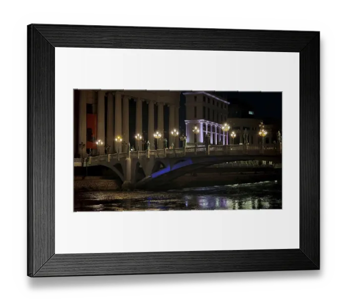 Framed Print : Illuminated bridge over a river at night with urban architecture in the background Framed Print : Illuminated bridge over a river at night with urban architecture in the background