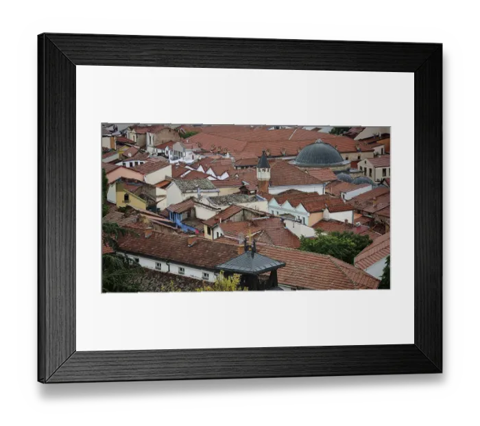Framed Print : View of an old town with red tiled roofs and a dome