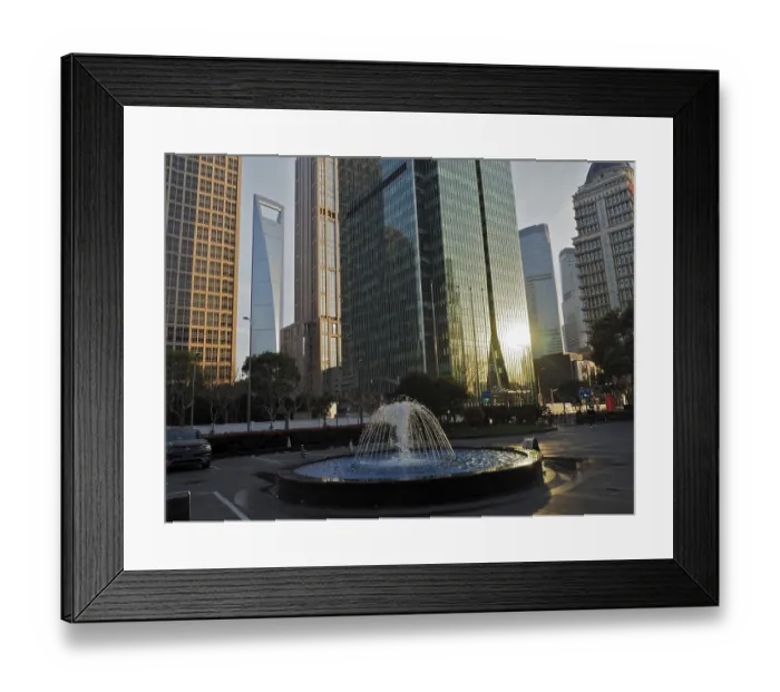 Framed Print : Skyscrapers with reflective glass facades and a fountain in the city center