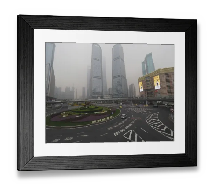 Framed Print : City scene with roundabout and skyscrapers in fog under grey sky