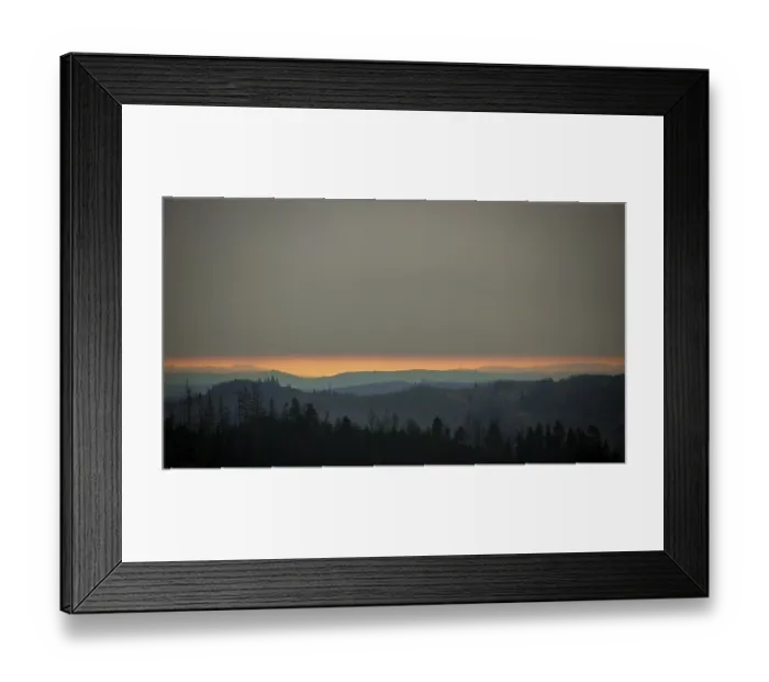 Framed Print : Forest and mountains at dusk below a cloudy horizon