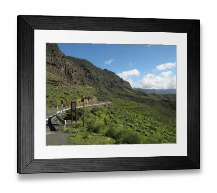 Framed Print : Scenic road through green mountains with clear skies