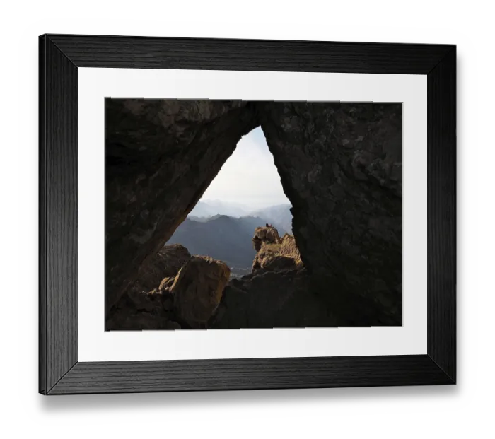 Framed Print : View through a rocky frame of a distant mountain landscape