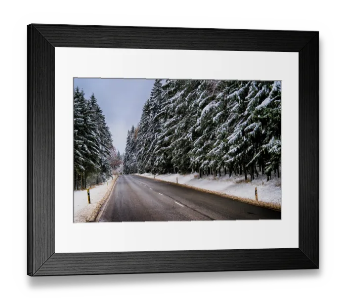 Framed Print : A snowy road leads through a quiet forest Framed Print : A snowy road leads through a quiet forest