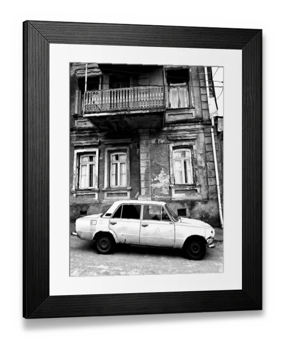 Framed Print : Monochrome, vintage car standing in front of a Nostaligian building with a distinctive balcony