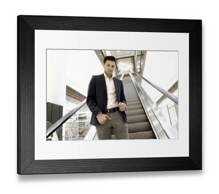 Framed Print : Confident young Afghan man in a navy blazer business suit on an escalator in a modern building of shopping mall Framed Print : Confident young Afghan man in a navy blazer business suit on an escalator in a modern building of shopping mall