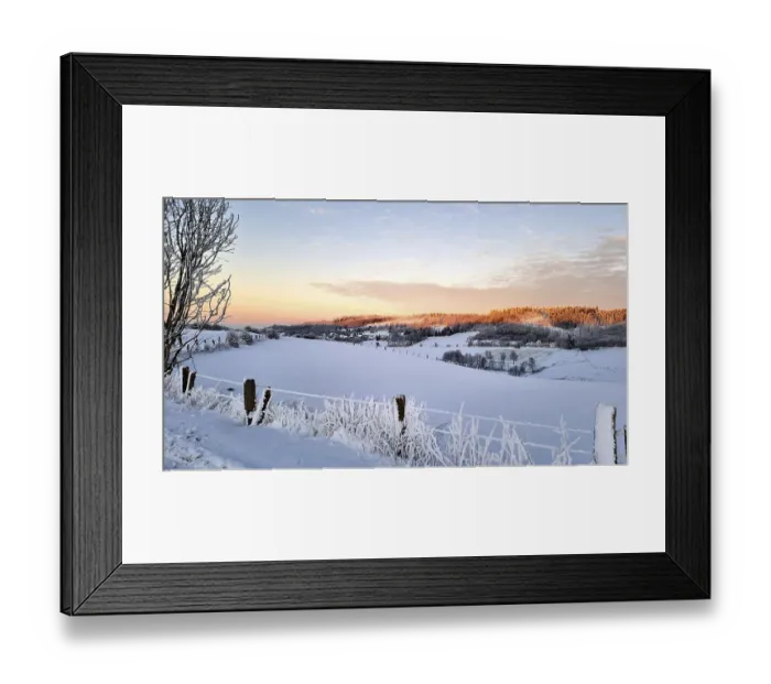 Framed Print : Snowy landscape at sunrise with hills and trees