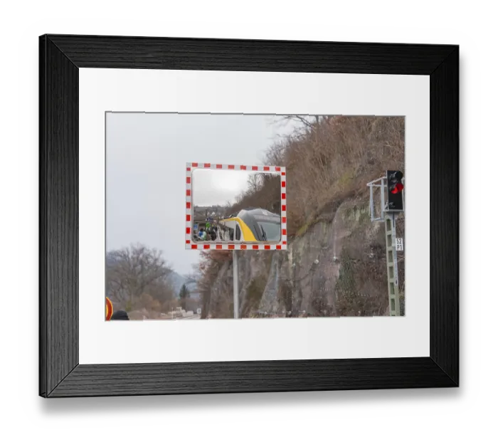 Framed Print : A mirror depicts a train and people waiting in a landscape