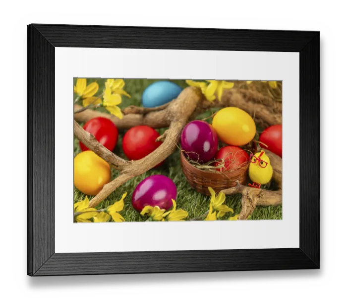Framed Print : Colourful Easter eggs in and around a small basket Framed Print : Colourful Easter eggs in and around a small basket