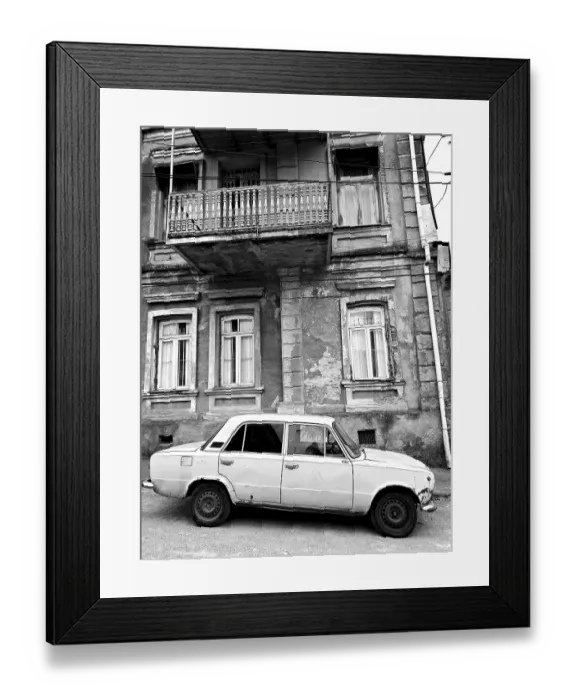 Framed Print : Monochrome, vintage car standing in front of a Nostaligian building with a distinctive balcony