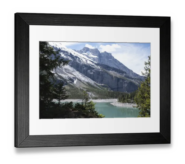 Framed Print : Turquoise alpine lake surrounded by coniferous forests and snow-capped peaks Oeschinen Lake
