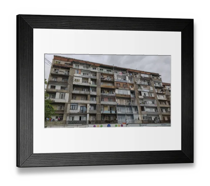 Framed Print : Large apartment block with many floors and balconies under cloudy sky