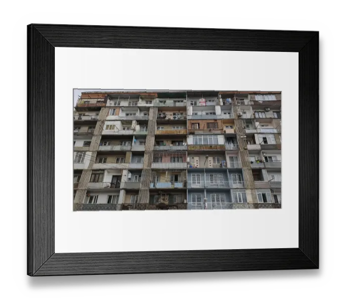 Framed Print : Front view of a symmetrical apartment block with many balconies and floors Framed Print : Front view of a symmetrical apartment block with many balconies and floors