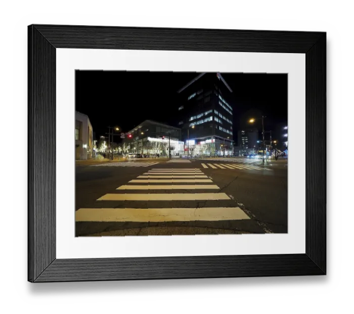 Framed Print : Modern buildings light up a nocturnal intersection full of lights