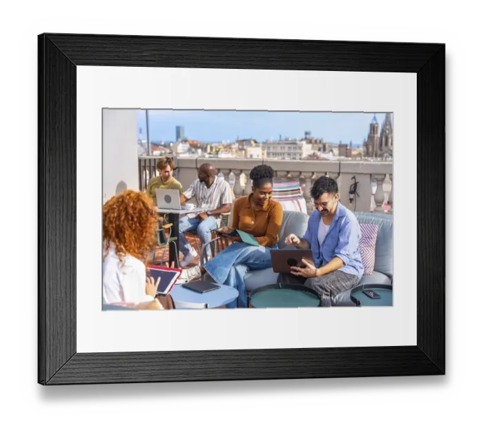 Framed Print : Group of diverse business people meeting and working together casually on a rooftop terrace