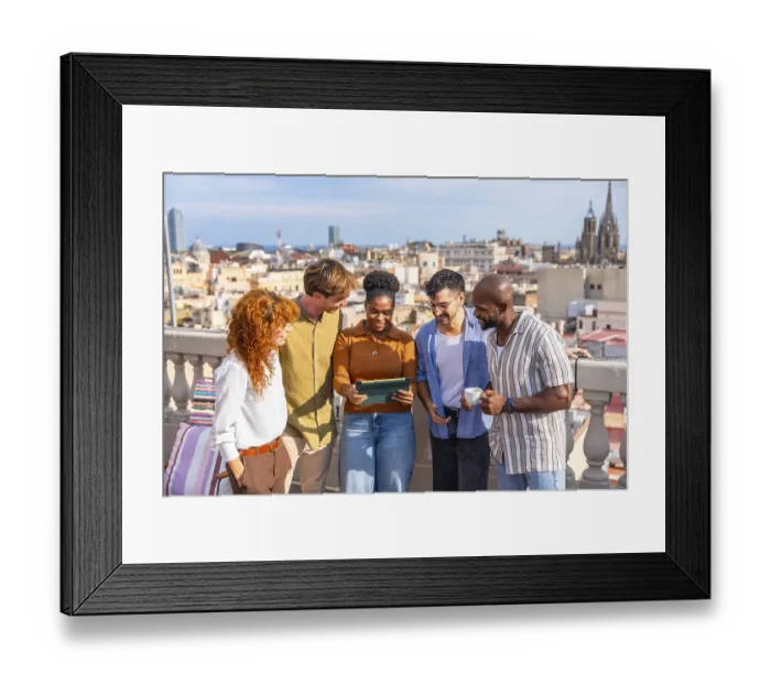 Framed Print : Diverse colleagues networking and smiling on a sunny barcelona rooftop during a casual work break