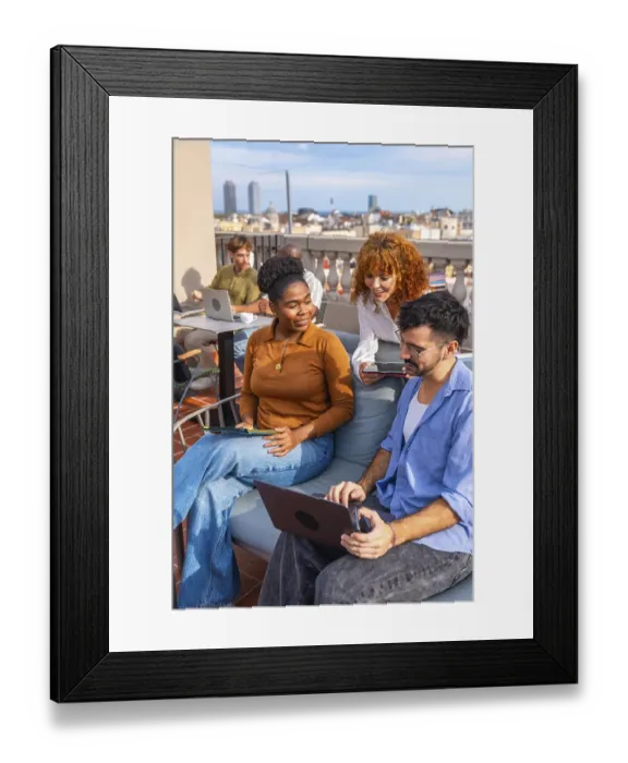 Framed Print : Diverse colleagues collaborating and sharing ideas while working on laptops Framed Print : Diverse colleagues collaborating and sharing ideas while working on laptops