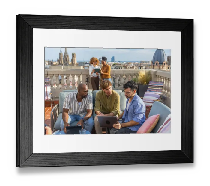 Framed Print : Diverse colleagues collaborate on a rooftop terrace in barcelona during a break