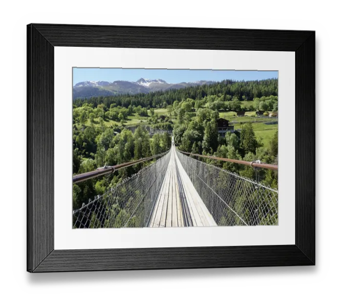 Framed Print : Impressive suspension bridge stretching in the green forest landscape of the Alps