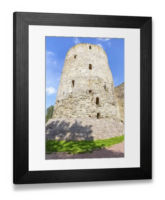 Framed Print : Stone tower of the ancient Izborsk fortress against a blue sky in summer