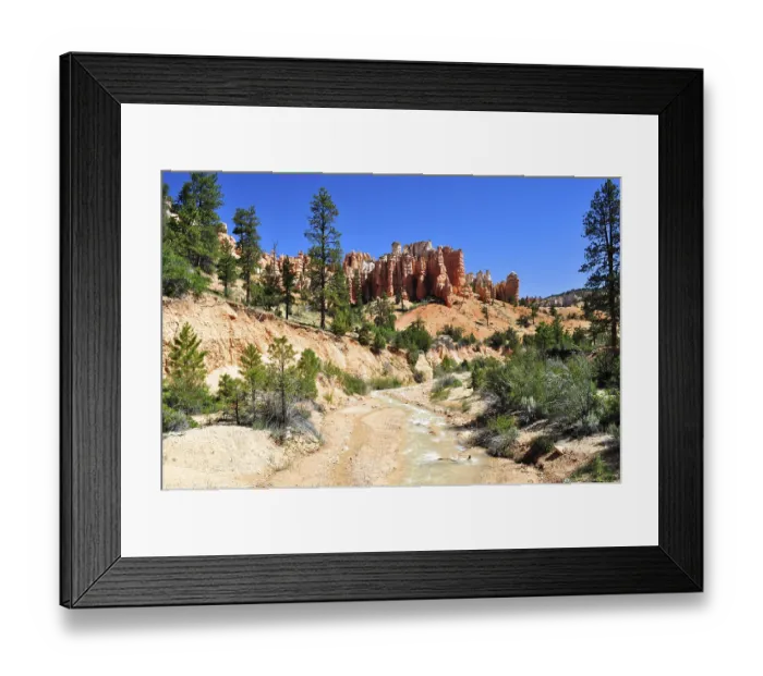 Framed Print : A small river flows through a landscape of distinctive rock formations and forest Framed Print : A small river flows through a landscape of distinctive rock formations and forest