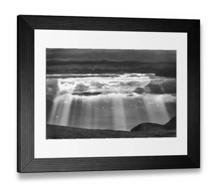 Framed Print : Sun rays fall through clouds in mountain landscape Framed Print : Sun rays fall through clouds in mountain landscape