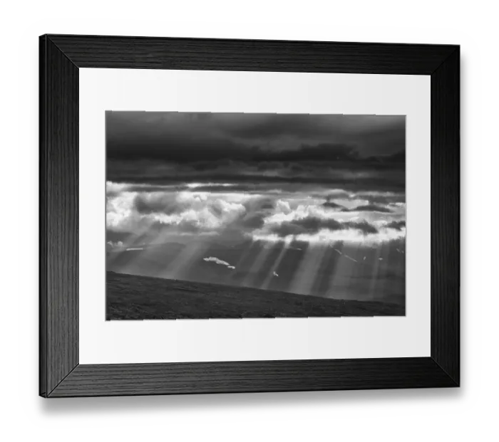 Framed Print : Sun rays fall through clouds in mountain landscape Framed Print : Sun rays fall through clouds in mountain landscape